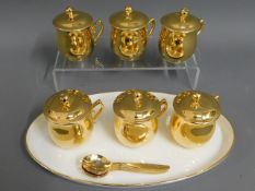 A set of six Royal Worcester gilded chocolate pots