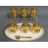 A set of six Royal Worcester gilded chocolate pots