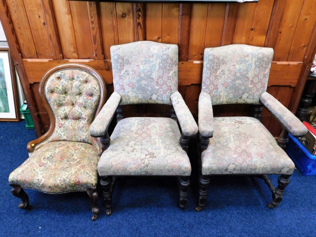 A Victorian oak framed nursing chair, one leg lacking wheel, twinned with two early 20thC. arm chair