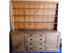 A large antique pitch pine dresser with two cupboa