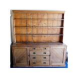 A large antique pitch pine dresser with two cupboa