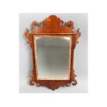 A decorative Georgian mahogany frame with later mi