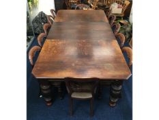 A large English oak extending table with inserts,