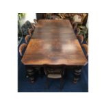 A large English oak extending table with inserts,