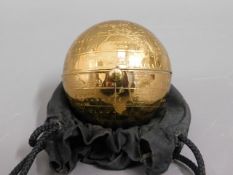 A brass globe compact, clasp stiff