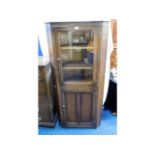A glazed oak corner cabinet, 66in high x 31in wide