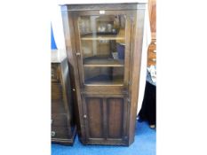 A glazed oak corner cabinet, 66in high x 31in wide