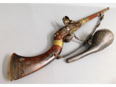 A 19thC. middle eastern flintlock rifle with powde
