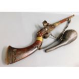 A 19thC. middle eastern flintlock rifle with powde