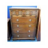 A mid 20thC. oak chest with four drawers & two cup
