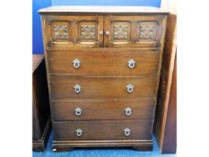 A mid 20thC. oak chest with four drawers & two cup