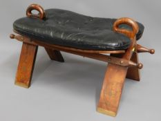 A leather seated camel chair with brass inlay