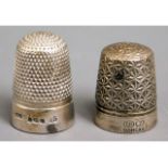 A hallmarked silver thimble twinned with another m