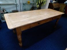 A scrub top pine farmhouse table with two drawers,