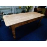 A scrub top pine farmhouse table with two drawers,