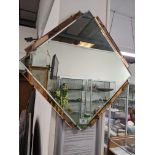 A mid 20thC. mirror, small crack to one peach edge