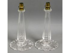 A pair of cut glass candle holder bases with brass