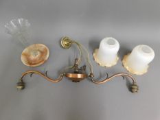 A copper ceiling lamp with two glass shades twinne