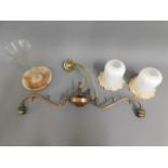 A copper ceiling lamp with two glass shades twinne