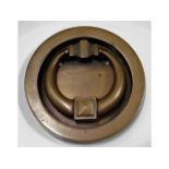 A recessed bronze door knocker, 5in diameter
