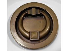 A recessed bronze door knocker, 5in diameter