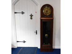 A 1920's oak chiming long case clock with brass di