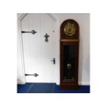 A 1920's oak chiming long case clock with brass di