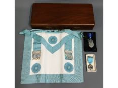 A cased Masonic apron with two medals, one Royal M