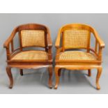 Two cane seated arm chairs. 34.5in high to back, 2