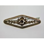 A silver brooch set with marcasite on thistle deco
