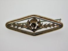 A silver brooch set with marcasite on thistle deco