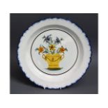 An 18thC. tin glaze delft plate with floral decor,