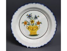 An 18thC. tin glaze delft plate with floral decor,