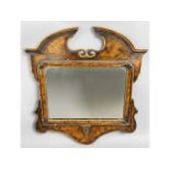 An 18thC. gesso framed mirror, carved crest to rea