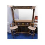 An Old Charm oak home bar with two stools, shelf rack, optics & glasses supplied, 64.75in high x 62.