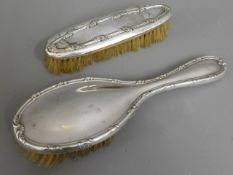 Two early 20thC. silver backed brushes