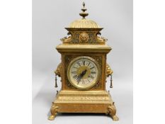 A decorative French brass mantle clock