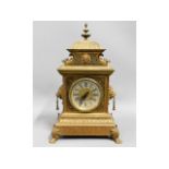 A decorative French brass mantle clock