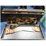 A carpenters tool case with tools including saws &