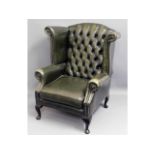 A leather Chesterfield style wing back armchair, 4
