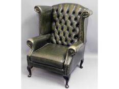 A leather Chesterfield style wing back armchair, 4