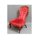 A 19thC. rosewood button back nursing chair, 35.5i