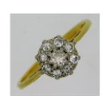 An antique 18ct gold (rubbed mark) daisy ring of a
