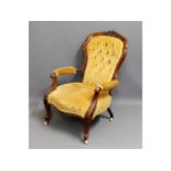 A 19thC. rosewood button back armchair, fault to o