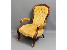 A 19thC. rosewood button back armchair, fault to o