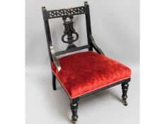 An ebonised Edwardian nursing chair