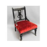 An ebonised Edwardian nursing chair