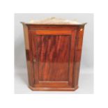 A Georgian mahogany corner cabinet, 35.5in high x 27.5in wide x 16in deep