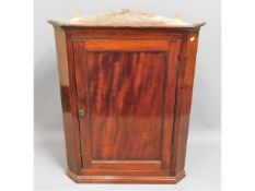 A Georgian mahogany corner cabinet, 35.5in high x 27.5in wide x 16in deep