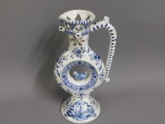 A late 19thC. delft faience puzzle jug, 10in tall